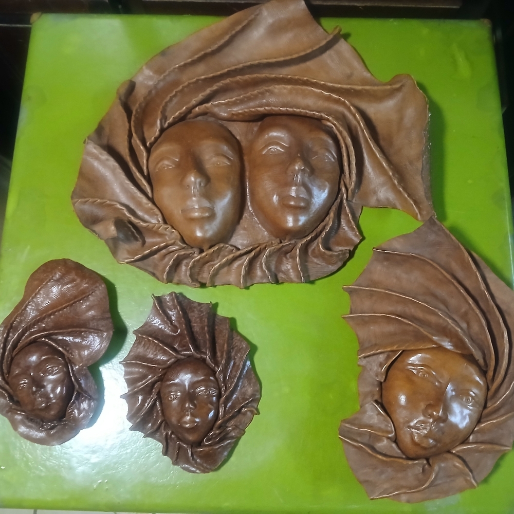 vintage handmade leather folk art wall sculptures.